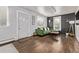 Comfortable living room featuring hardwood floors, a green sofa, and modern decor at 3464 S Downing St, Englewood, CO 80113