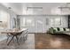 Bright living room with hardwood floors, a comfortable green sofa, and natural light at 3464 S Downing St, Englewood, CO 80113