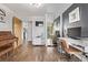 Stylish living room with hardwood floors, neutral walls, access to a patio, a modern desk and a piano at 3464 S Downing St, Englewood, CO 80113