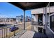 Relaxing outdoor balcony with black metal railing, seating, and views of a modern neighborhood at 6240 N Dayton Ct, Denver, CO 80238