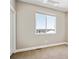 Empty bedroom featuring a large window allowing natural light and neutral-toned carpeting at 6240 N Dayton Ct, Denver, CO 80238