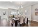 Open dining room with a chandelier, a modern table set, and large windows for natural light at 6240 N Dayton Ct, Denver, CO 80238