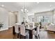 Spacious dining area features a large table, elegant seating, and views of the open-concept living space at 6240 N Dayton Ct, Denver, CO 80238
