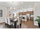 Open-concept dining area flowing into a modern kitchen with stainless steel appliances at 6240 N Dayton Ct, Denver, CO 80238