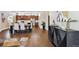 Open dining room with kitchen view featuring dark hardwood floors and a modern aesthetic at 6240 N Dayton Ct, Denver, CO 80238