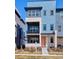 Contemporary townhome with a second story balcony, and stylish blue and grey siding at 6240 N Dayton Ct, Denver, CO 80238