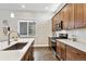 Well-equipped kitchen with stainless steel appliances, quartz countertops, and ample cabinet space at 6240 N Dayton Ct, Denver, CO 80238