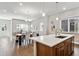 Bright, open-concept living space showcases a kitchen island adjacent to the elegant dining room at 6240 N Dayton Ct, Denver, CO 80238
