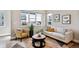 Comfortable living room with stylish furnishings, a patterned rug, and bright windows at 6240 N Dayton Ct, Denver, CO 80238