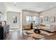 Inviting living room with comfortable seating, a patterned rug, and plenty of natural light from the windows at 6240 N Dayton Ct, Denver, CO 80238