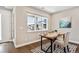 Bright home office boasts a modern desk, neutral walls, and large window overlooking the street at 6240 N Dayton Ct, Denver, CO 80238