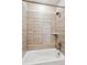 Clean bathroom tub and shower combo with tile surround and modern fixtures at 6240 N Dayton Ct, Denver, CO 80238