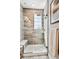 Sleek glass-enclosed shower with modern tile, a rainfall showerhead, and a built-in bench at 6240 N Dayton Ct, Denver, CO 80238