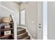 Entry staircase with wood treads, white risers, and rustic shelving to the left at 6240 N Dayton Ct, Denver, CO 80238