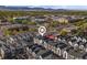 Stunning aerial view of townhomes in an idyllic community with mountain backdrop and close proximity to shops and businesses at 5173 Vivian St, Wheat Ridge, CO 80033