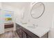 Bathroom featuring double sinks with wood cabinets at 5173 Vivian St, Wheat Ridge, CO 80033
