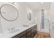 Bathroom featuring double sinks and glass enclosed shower at 5173 Vivian St, Wheat Ridge, CO 80033