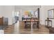 The dining room features hardwood floors and is open to the kitchen with lots of natural light at 5173 Vivian St, Wheat Ridge, CO 80033