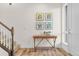 Bright entryway featuring hard surface floors, decorative wall art and a staircase to upper level at 5173 Vivian St, Wheat Ridge, CO 80033