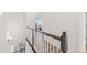 Bright hallway upstairs with wood floors and white staircase leading to bedrooms at 5173 Vivian St, Wheat Ridge, CO 80033