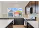 The kitchen offers views of the outside and great space for cooking and entertaining at 5173 Vivian St, Wheat Ridge, CO 80033