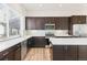Modern kitchen boasting stainless steel appliances, ample cabinet space, and sleek countertops at 5173 Vivian St, Wheat Ridge, CO 80033