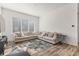 Spacious living room with hardwood floors, neutral paint, large sofa and ample natural light at 5173 Vivian St, Wheat Ridge, CO 80033