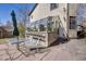 Backyard featuring a greenhouse, an outdoor dining set, and a stone patio at 306 E Cannon St, Lafayette, CO 80026