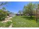 Expansive backyard with mature trees and a well-maintained lawn at 306 E Cannon St, Lafayette, CO 80026