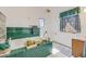 Bright bathroom featuring a bathtub with vibrant green tiles and a large window at 306 E Cannon St, Lafayette, CO 80026