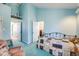 Bright bedroom featuring a comfortable bed, a sitting area and light blue painted walls at 306 E Cannon St, Lafayette, CO 80026