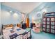 Bright bedroom featuring a comfortable bed, a unique window and blue painted walls at 306 E Cannon St, Lafayette, CO 80026