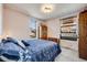 Bright bedroom with a large bed, natural light, and hardwood furnishings at 306 E Cannon St, Lafayette, CO 80026