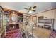 Dining room featuring a ceiling fan, patterned wallpaper and large wood shelving at 306 E Cannon St, Lafayette, CO 80026