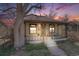Inviting home showcasing a quaint covered porch, perfect for enjoying serene evenings and a colorful sky at 306 E Cannon St, Lafayette, CO 80026
