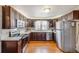Modern kitchen with stainless steel appliances, white countertops, and dark wood cabinets at 306 E Cannon St, Lafayette, CO 80026
