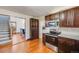 Kitchen with stainless steel appliances, granite countertops, and dark wood cabinets at 306 E Cannon St, Lafayette, CO 80026