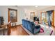 Bright living room with hardwood floors, large windows, and a blue sofa at 306 E Cannon St, Lafayette, CO 80026