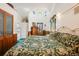 Comfortable main bedroom featuring unique round windows and wood-paneled closets at 306 E Cannon St, Lafayette, CO 80026