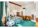 Comfortable main bedroom featuring a cathedral ceiling, an ensuite, and wood paneled walls at 306 E Cannon St, Lafayette, CO 80026