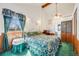 Cozy main bedroom featuring a cathedral ceiling, a ceiling fan and an ensuite at 306 E Cannon St, Lafayette, CO 80026