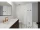 Modern bathroom with gray tile and gold fixtures at 5577 E Links Cir, Centennial, CO 80122