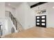 Elegant entryway with modern staircase and light fixtures at 5577 E Links Cir, Centennial, CO 80122