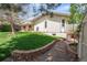 Spacious backyard with a lush lawn, garden, and pathway, ideal for outdoor activities and relaxation at 12662 W Asbury Pl, Lakewood, CO 80228