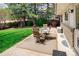 Inviting backyard patio featuring a dining set and lush greenery, perfect for outdoor relaxation at 12662 W Asbury Pl, Lakewood, CO 80228