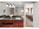 Bathroom features double sinks, granite counters, walk-in shower, and a glimpse into the adjacent bedroom at 12662 W Asbury Pl, Lakewood, CO 80228