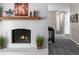 Charming white brick fireplace with wood mantel, complemented by decorative accents and adjacent hallway at 12662 W Asbury Pl, Lakewood, CO 80228