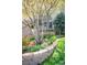 Lush garden with tulips and flowers, framed by a brick retaining wall at 12662 W Asbury Pl, Lakewood, CO 80228