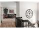 Hallway view leading to a living area, showcasing neutral carpeting, an accent wall, and natural light at 12662 W Asbury Pl, Lakewood, CO 80228