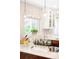 Bright kitchen features granite countertops, stainless appliances, a stylish window treatment, and pendant lighting at 12662 W Asbury Pl, Lakewood, CO 80228